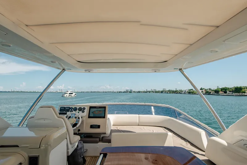 Slide: The Image of Flybridge view from 2016 Azimut 64 yacht, overlooking serene waters and distant shoreline. - 11