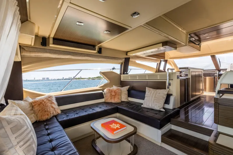 Slide: The Image of Luxurious interior of 2016 Azimut 64 Flybridge yacht with plush seating and scenic ocean view. - 16