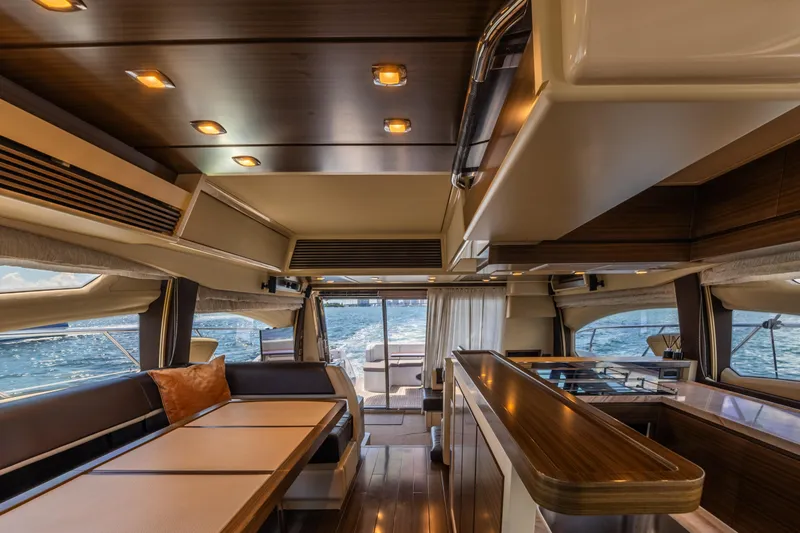 Slide: The Image of Luxurious interior of 2016 Azimut 64 Flybridge yacht with elegant wood finishes and ocean view. - 22