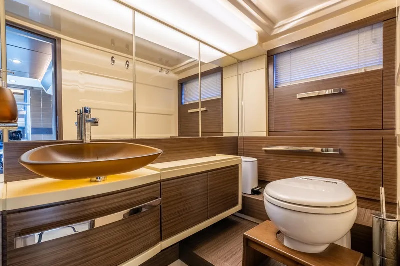Slide: The Image of Luxurious bathroom in 2016 Azimut 64 Flybridge yacht with modern fixtures and wood accents. - 27