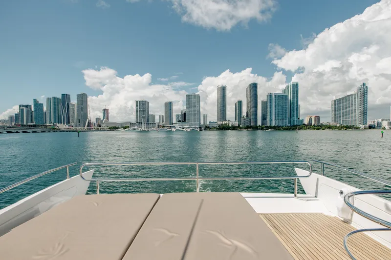 Slide: The Image of 2016 Azimut 64 Flybridge yacht with city skyline view, sunny day. - 8