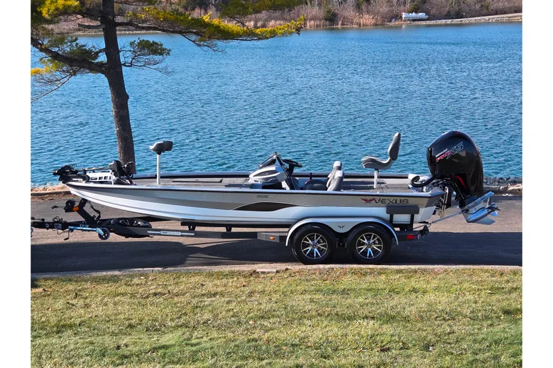 The Image of 2023 Vexus AVX1980 boat on trailer by a scenic lake. - 0