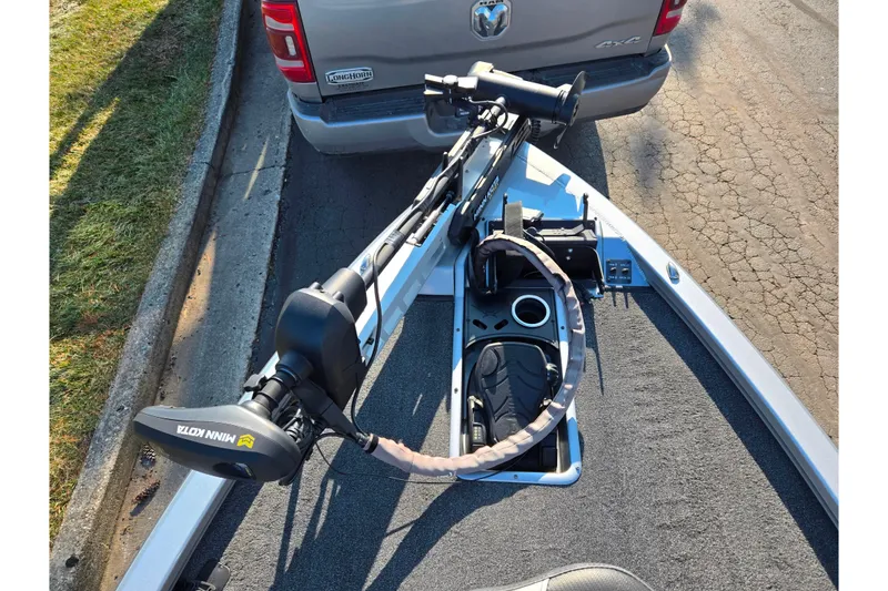 Slide: The Image of 2023 Vexus AVX1980 boat with Minn Kota trolling motor, parked behind a truck. - 16