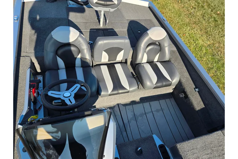 Slide: The Image of 2023 Vexus AVX1980 boat interior with sleek seating and steering wheel. - 18