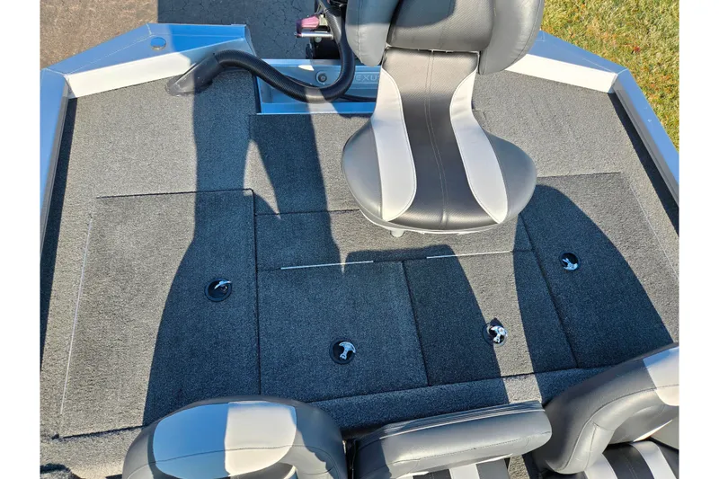 Slide: The Image of 2023 Vexus AVX1980 boat interior with gray carpet and black seats. - 19