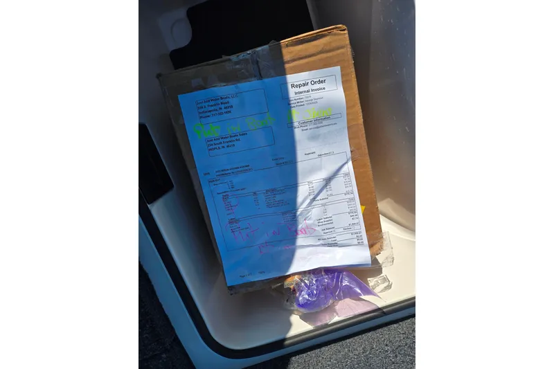 Slide: The Image of Box with repair order inside a 2023 Vexus AVX1980 boat compartment. - 20