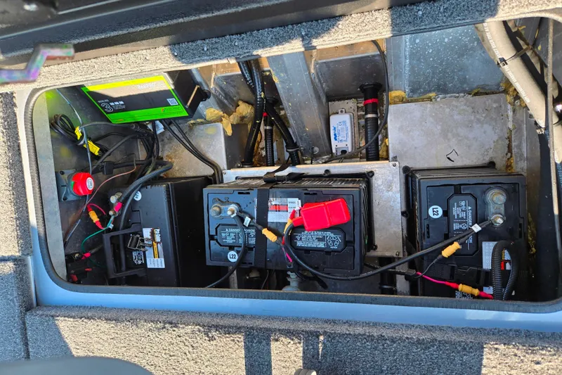 Slide: The Image of 2023 Vexus AVX1980 boat battery compartment with multiple batteries and wiring. - 22