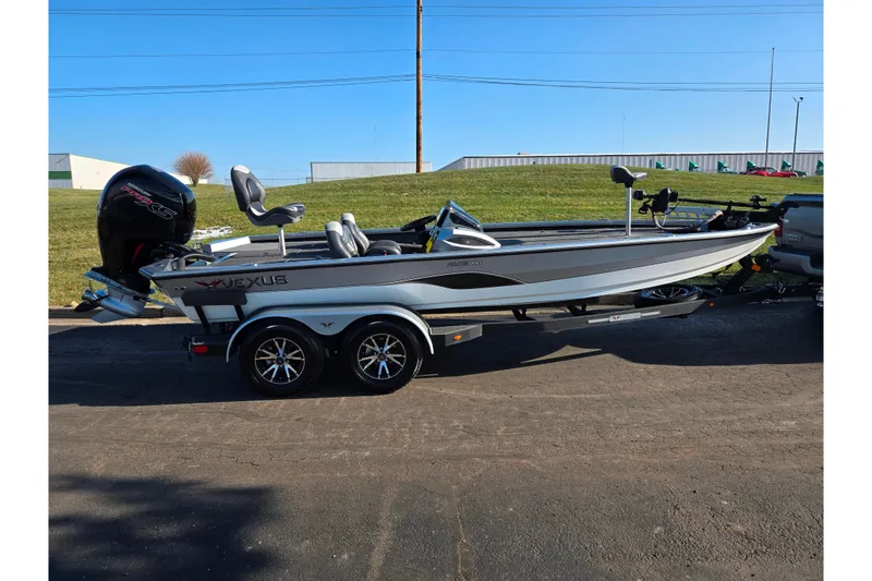 Slide: The Image of 2023 Vexus AVX1980 boat on trailer, parked outdoors under clear blue sky. - 4