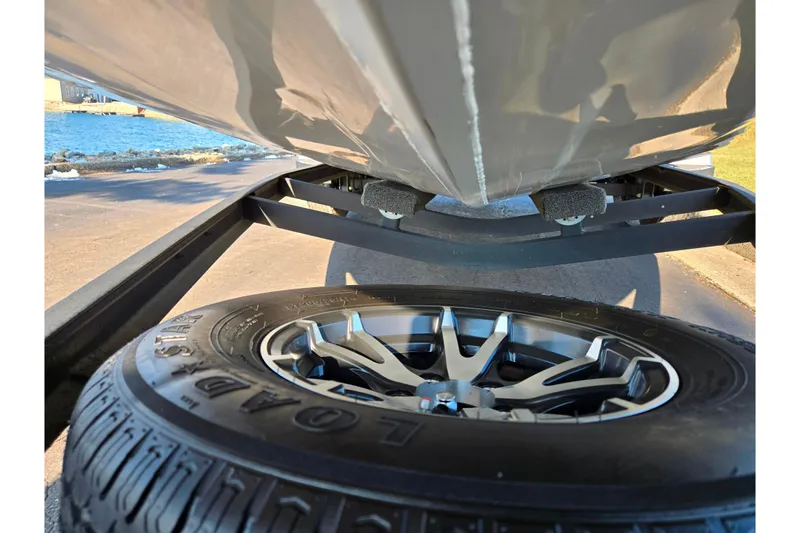 Slide: The Image of 2023 Vexus AVX1980 boat on trailer with Loadstar tire, lakeside view. - 7
