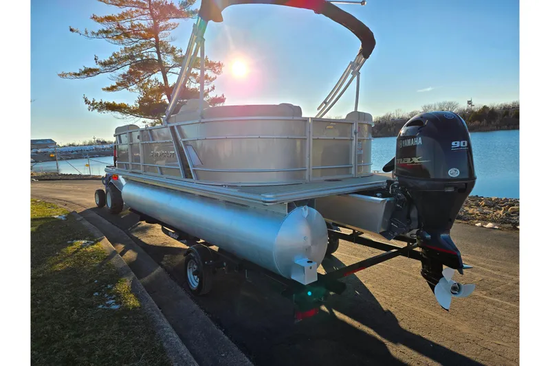 Slide: The Image of 2021 Starcraft EX 20 R pontoon boat with Yamaha outboard motor by a lakeside. - 1