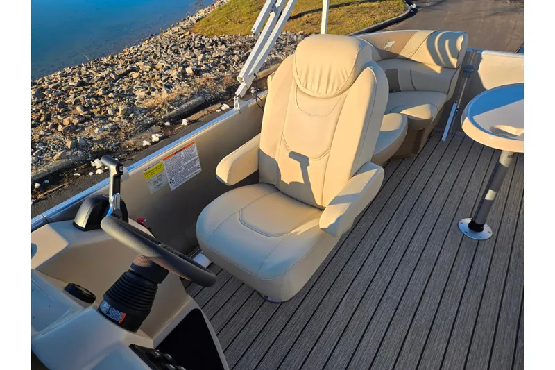 Slide: The Image of 2021 Starcraft EX 20 R boat interior with beige seating and steering wheel. - 13