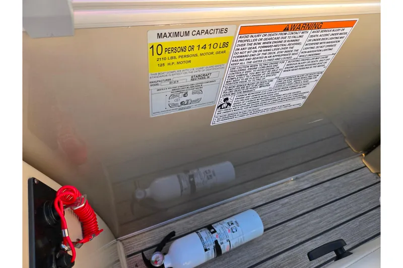 Slide: The Image of 2021 Starcraft EX 20 R boat capacity and safety warning labels with fire extinguisher. - 14