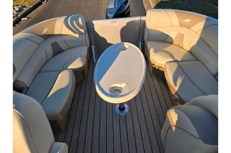 Slide: The Image of Luxurious seating on 2021 Starcraft EX 20 R boat with oval table, beige upholstery. - 15