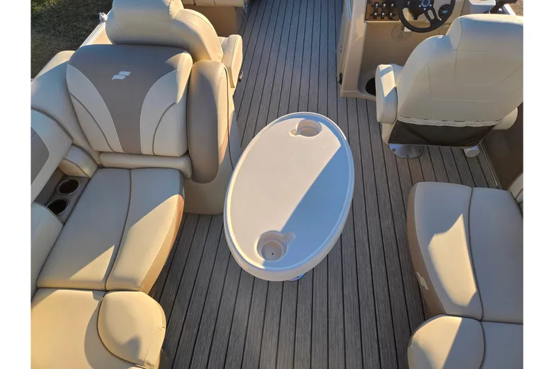 Slide: The Image of 2021 Starcraft EX 20 R boat interior with beige seating and oval table. - 17