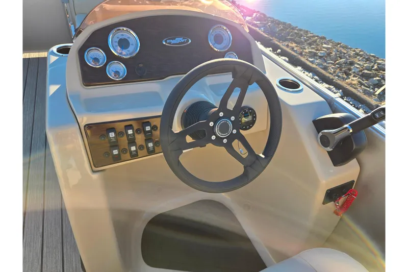 Slide: The Image of 2021 Starcraft EX 20 R boat dashboard with steering wheel and control panel. - 19