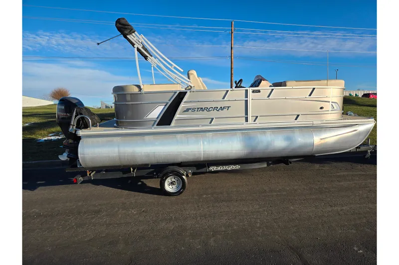 Slide: The Image of 2021 Starcraft EX 20 R pontoon boat on trailer, side view, clear sky background. - 4