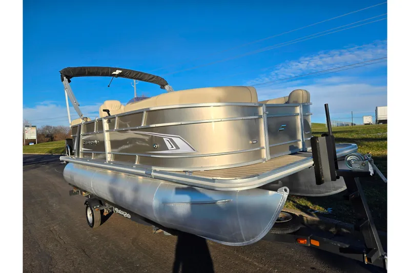 Slide: The Image of 2021 Starcraft EX 20 R pontoon boat on trailer under clear blue sky. - 5