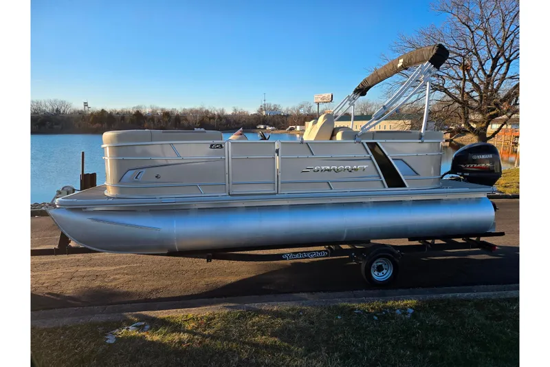 Slide: The Image of 2021 Starcraft EX 20 R pontoon boat on trailer by a lake. - 9