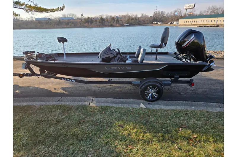 Slide: The Image of 2023 Lowe Stinger 175C fishing boat on trailer by a lake. - 10