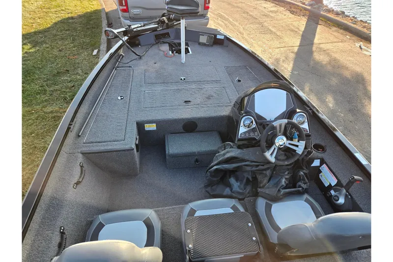 Slide: The Image of 2023 Lowe Stinger 175C boat interior with steering wheel and seating. - 11