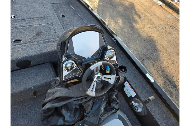 Slide: The Image of 2023 Lowe Stinger 175C boat dashboard with steering wheel and controls. - 12