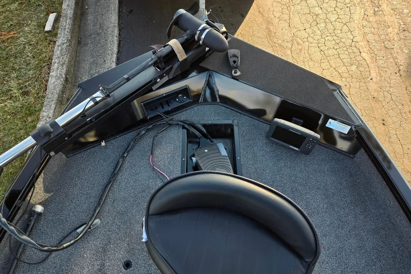 Slide: The Image of 2023 Lowe Stinger 175C boat interior with trolling motor and navigation equipment. - 17