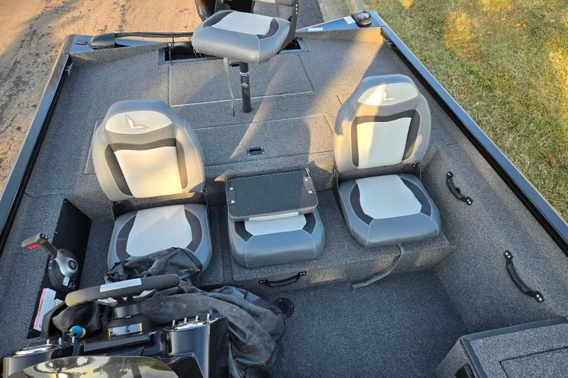 Slide: The Image of 2023 Lowe Stinger 175C boat interior with three seats and steering console. - 20