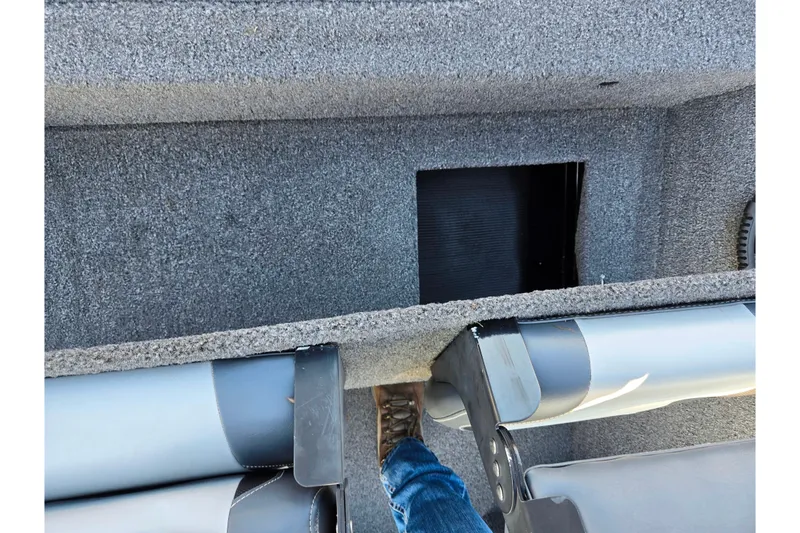 Slide: The Image of 2023 Lowe Stinger 175C boat interior with carpeted flooring and storage compartment. - 21