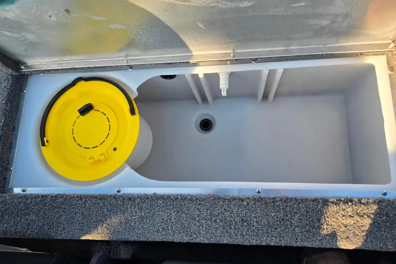 Slide: The Image of 2023 Lowe Stinger 175C livewell with yellow lid and drainage system. - 22
