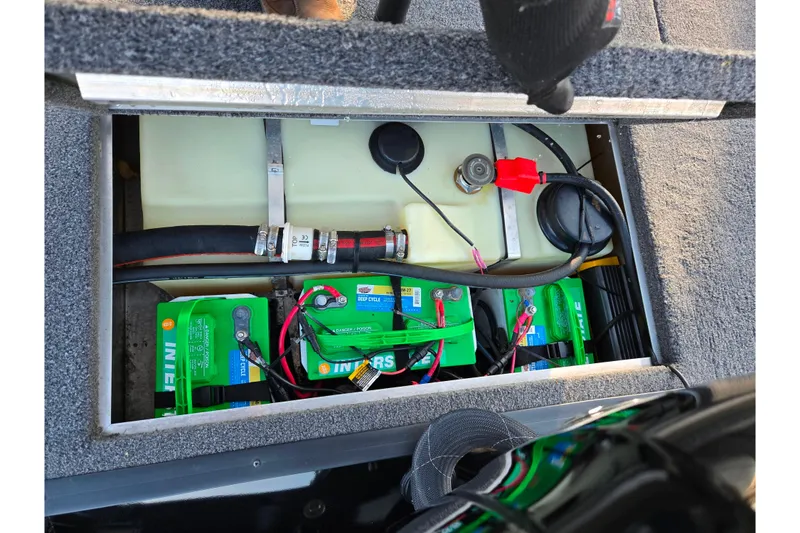Slide: The Image of 2023 Lowe Stinger 175C boat battery compartment with wiring and components. - 24