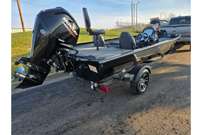 Slide: The Image of 2023 Lowe Stinger 175C boat with Mercury engine on a trailer, parked outdoors. - 3