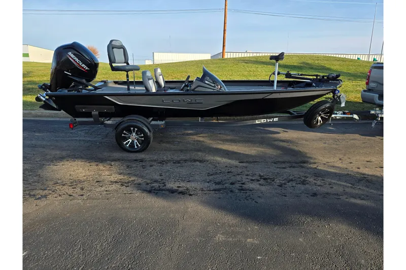 Slide: The Image of 2023 Lowe Stinger 175C fishing boat on trailer, parked outdoors. - 4