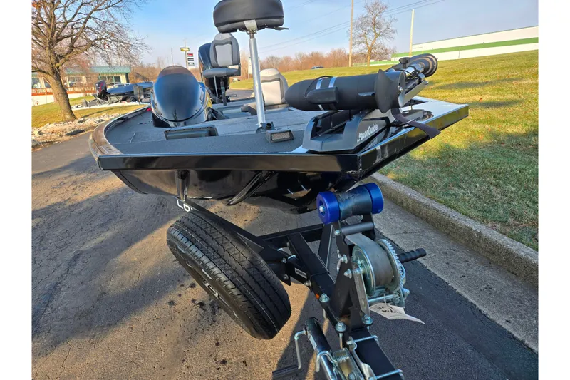 Slide: The Image of 2023 Lowe Stinger 175C boat on trailer, parked outdoors on a sunny day. - 6