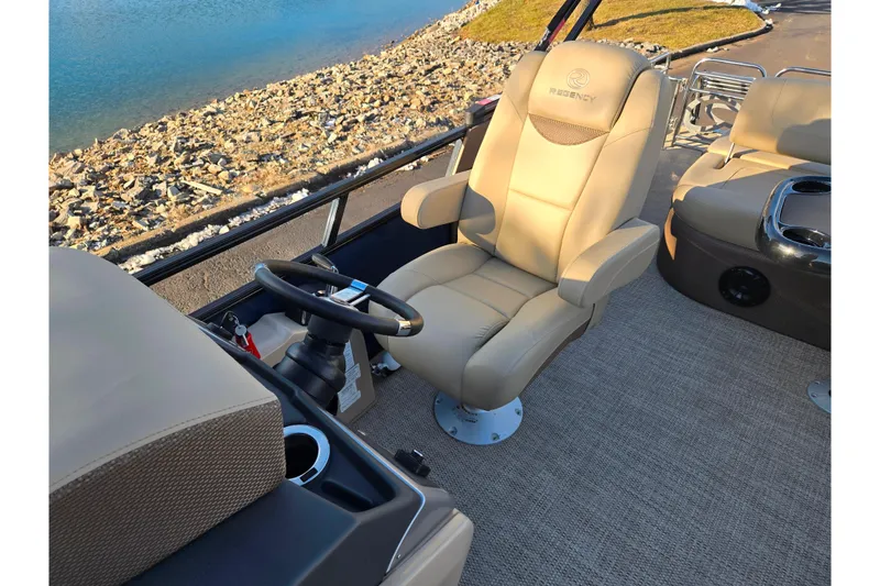 Slide: The Image of 2024 Regency 250 LE3 Sport boat interior with luxurious captain's chair and steering wheel. - 14