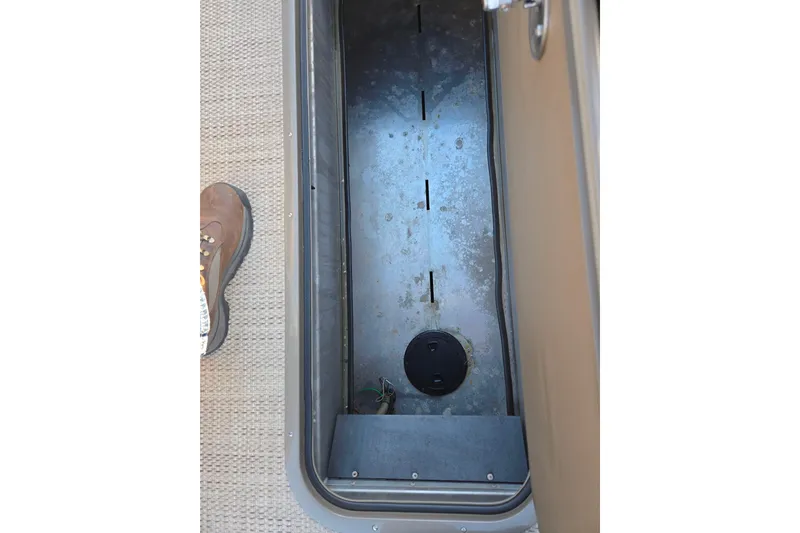 Slide: The Image of 2024 Regency 250 LE3 Sport storage compartment with open lid, showing interior details. - 24