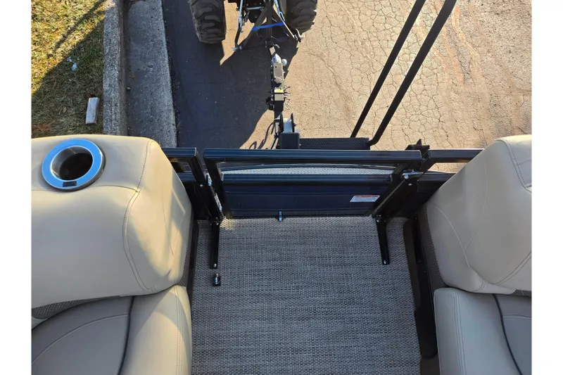 Slide: The Image of 2024 Regency 250 LE3 Sport boat interior with beige seating and cup holder. - 25