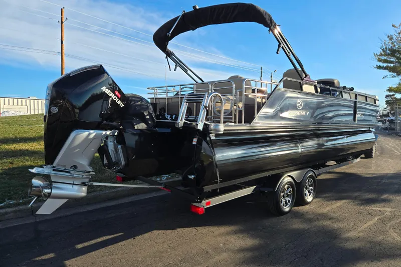 Slide: The Image of 2024 Regency 250 LE3 Sport pontoon boat with Mercury outboard engine on trailer. - 3