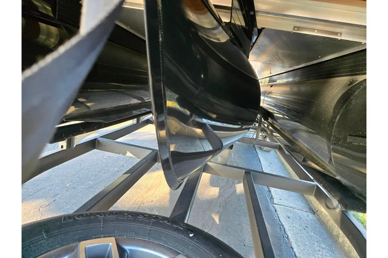 Slide: The Image of Underneath view of 2024 Regency 250 LE3 Sport pontoon boat on trailer. - 7