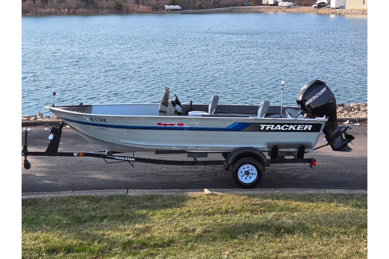 The Image of 1994 Tracker Pro Deep V-16 boat on trailer by a lake. - 0