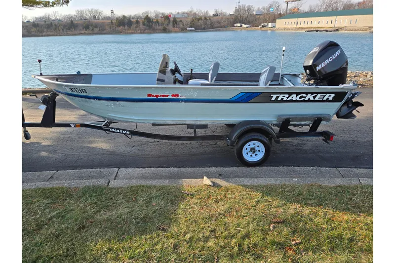 Slide: The Image of 1994 Tracker Pro Deep V-16 boat with Mercury engine on trailer by a lake. - 11