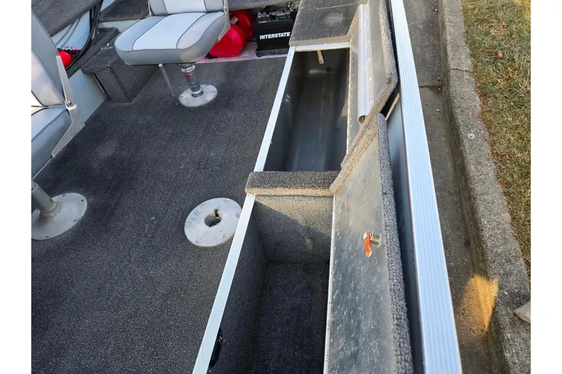 Slide: The Image of 1994 Tracker Pro Deep V-16 boat interior with open storage compartment and seating. - 13