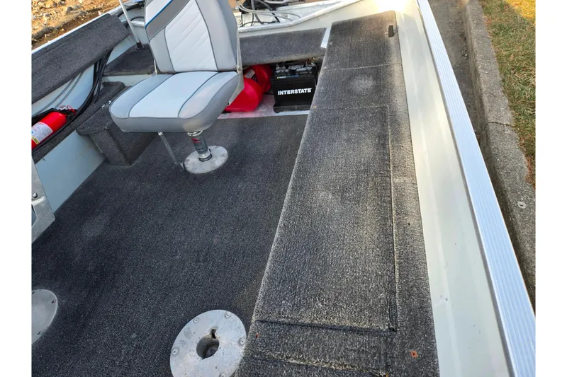 Slide: The Image of 1994 Tracker Pro Deep V-16 boat interior with seating and storage compartments. - 14