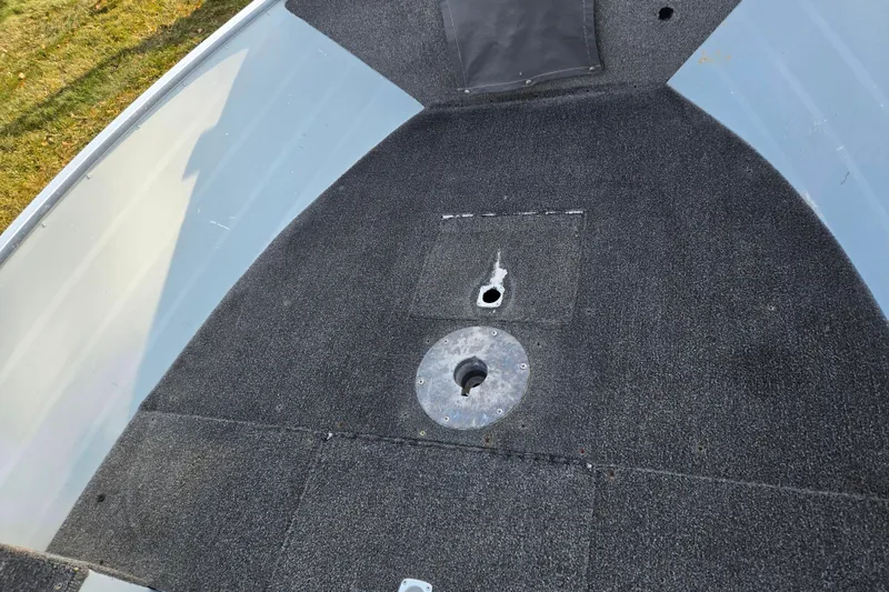Slide: The Image of 1994 Tracker Pro Deep V-16 boat interior with carpeted deck and mounting points. - 19