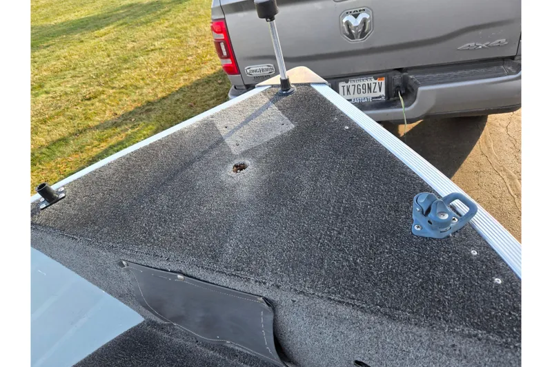 Slide: The Image of 1994 Tracker Pro Deep V-16 boat deck near a parked truck. - 20