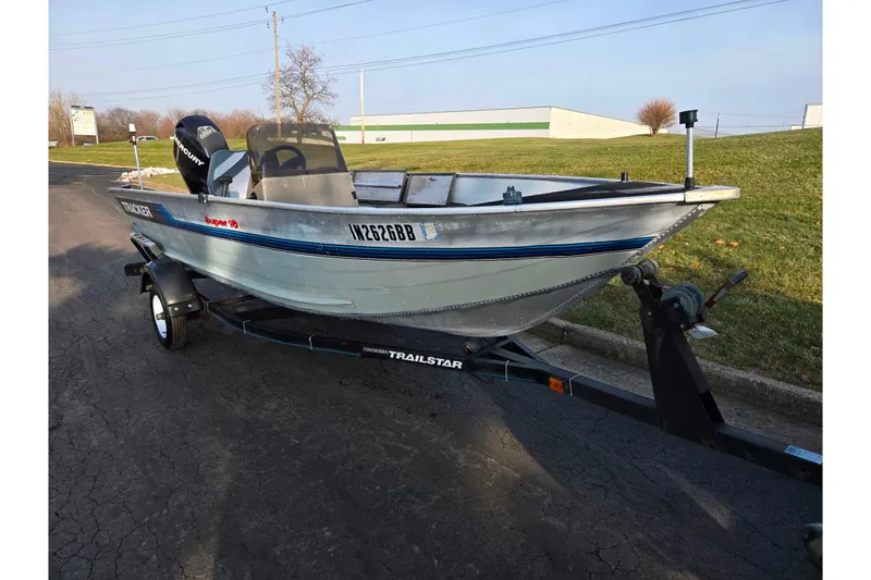 Slide: The Image of 1994 Tracker Pro Deep V-16 boat on trailer, parked on paved road. - 5