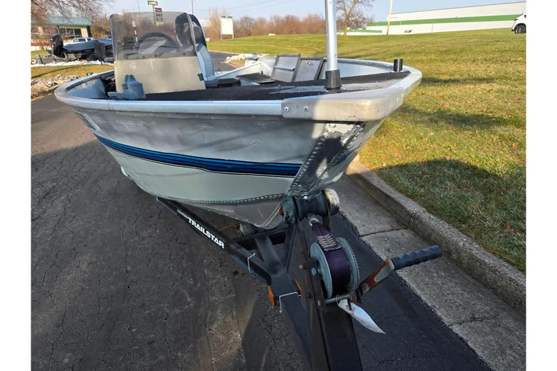 Slide: The Image of 1994 Tracker Pro Deep V-16 boat on trailer, parked on a paved road. - 6