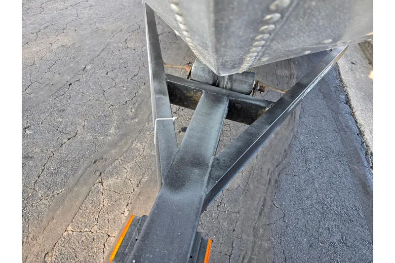 Slide: The Image of 1994 Tracker Pro Deep V-16 boat trailer on cracked pavement. - 7