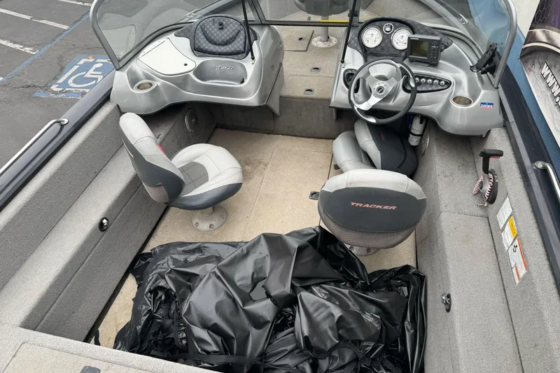 Slide: The Image of 2010 Tracker Targa 17 boat interior with steering wheel, seats, and dashboard controls. - 11