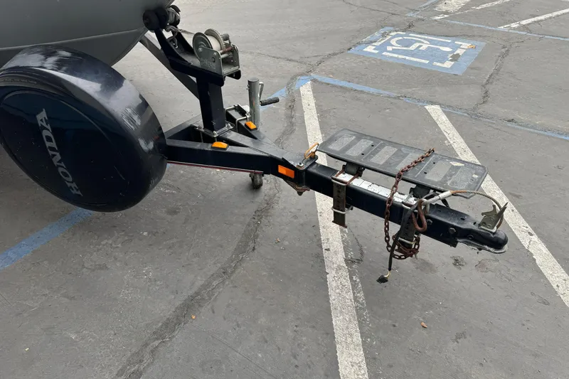 Slide: The Image of Trailer hitch of a 2010 Tracker Targa 17 in a parking lot. - 3
