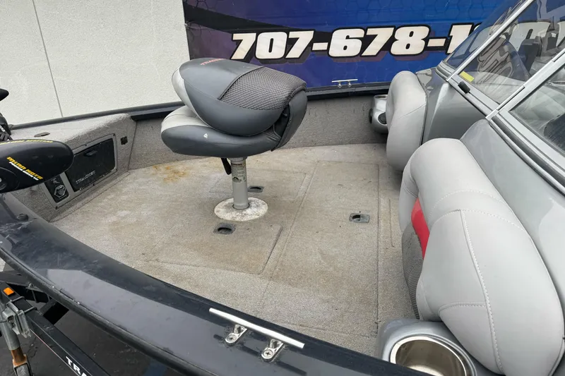Slide: The Image of 2010 Tracker Targa 17 boat interior with seating and carpeted deck. - 6